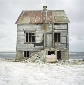 photo of dilapidated house on the beach